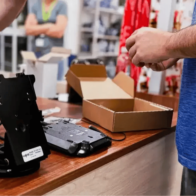 Man installing a card reader at a retail establishment